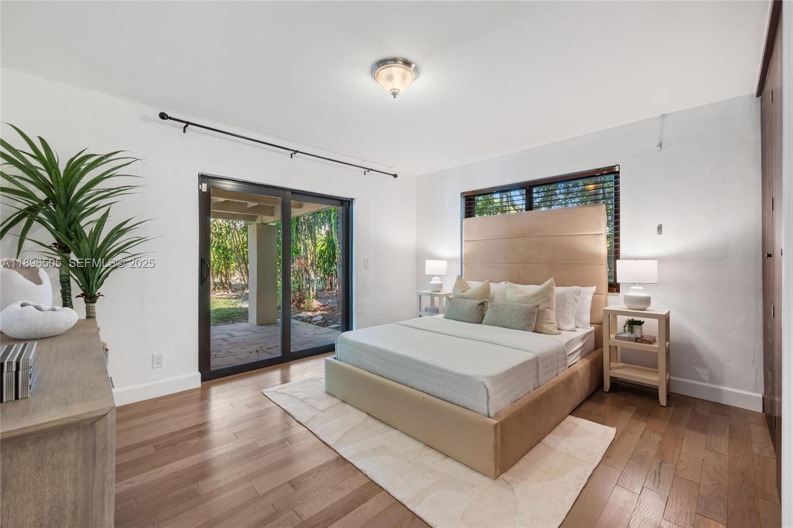 8501 Southwest 68th St Road Miami, FL 33143 - Photo 26 of 51 a bedroom with a large bed and a potted plant