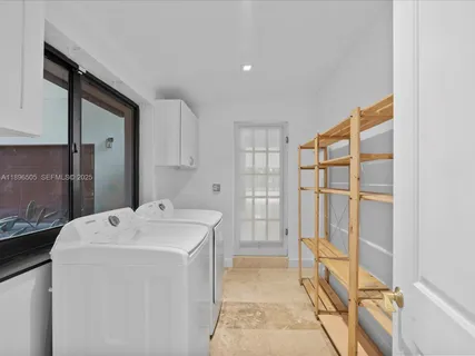 a living room with furniture gym equipment and a large window