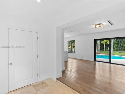 a view of a white house with a yard