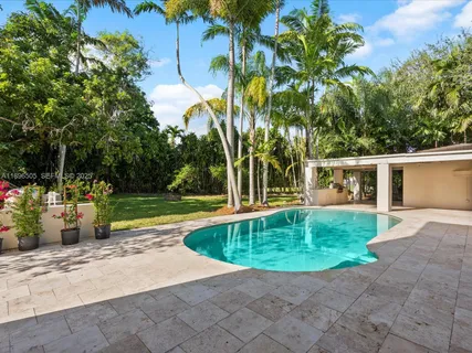 a view of a swimming pool and trees in the background