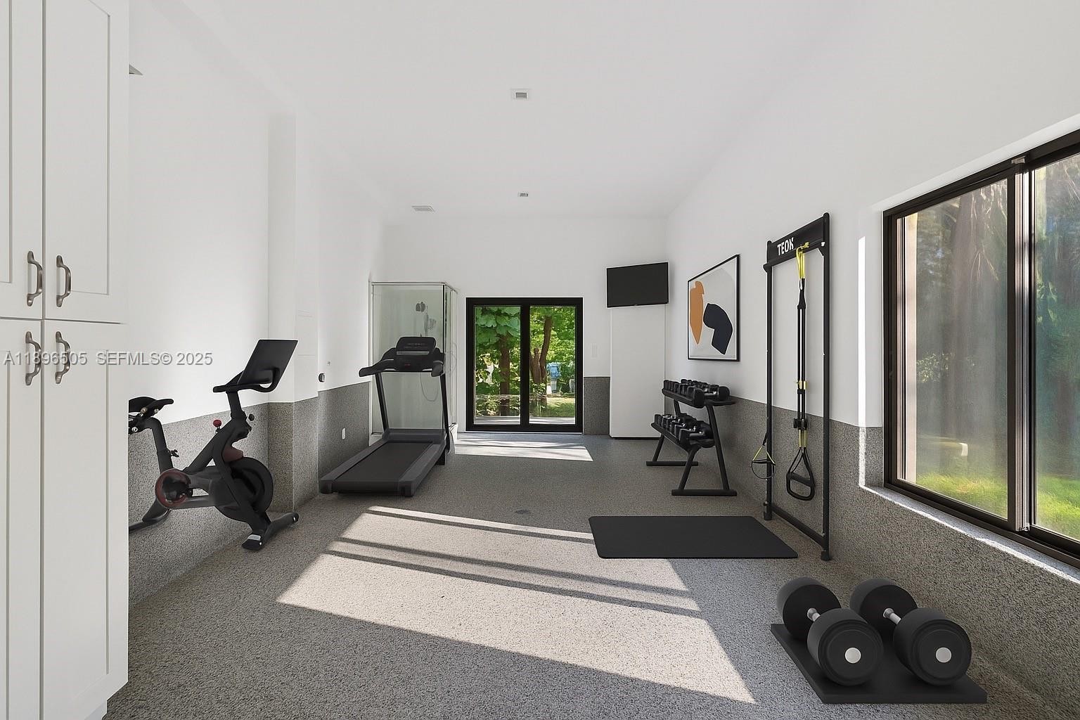 8501 Southwest 68th St Road Miami, FL 33143 - Photo 37 of 51 a living room with furniture gym equipment and a large window