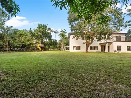 a view of a yard with a plant in a balcony