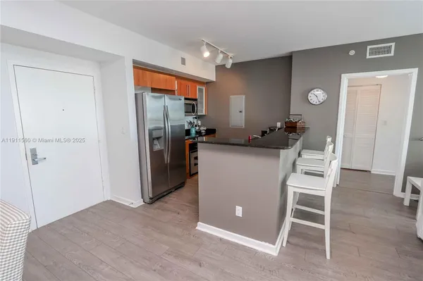 a kitchen with granite countertop a sink and a stove