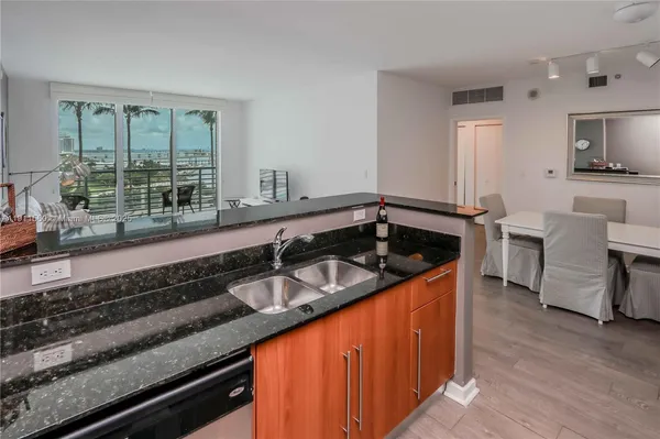 a bedroom with a bed and large windows