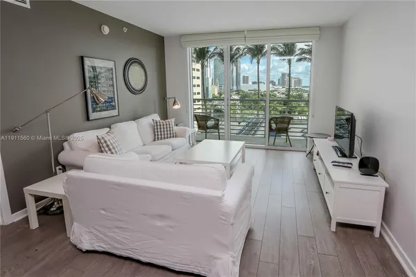 a kitchen with stainless steel appliances granite countertop a sink a stove and a wooden floors