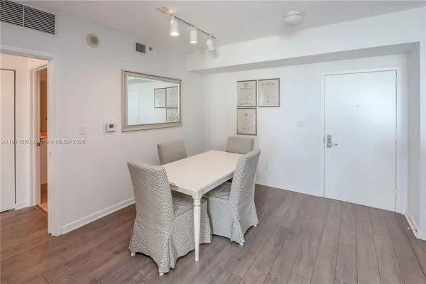 a dining room with a wooden table and chairs