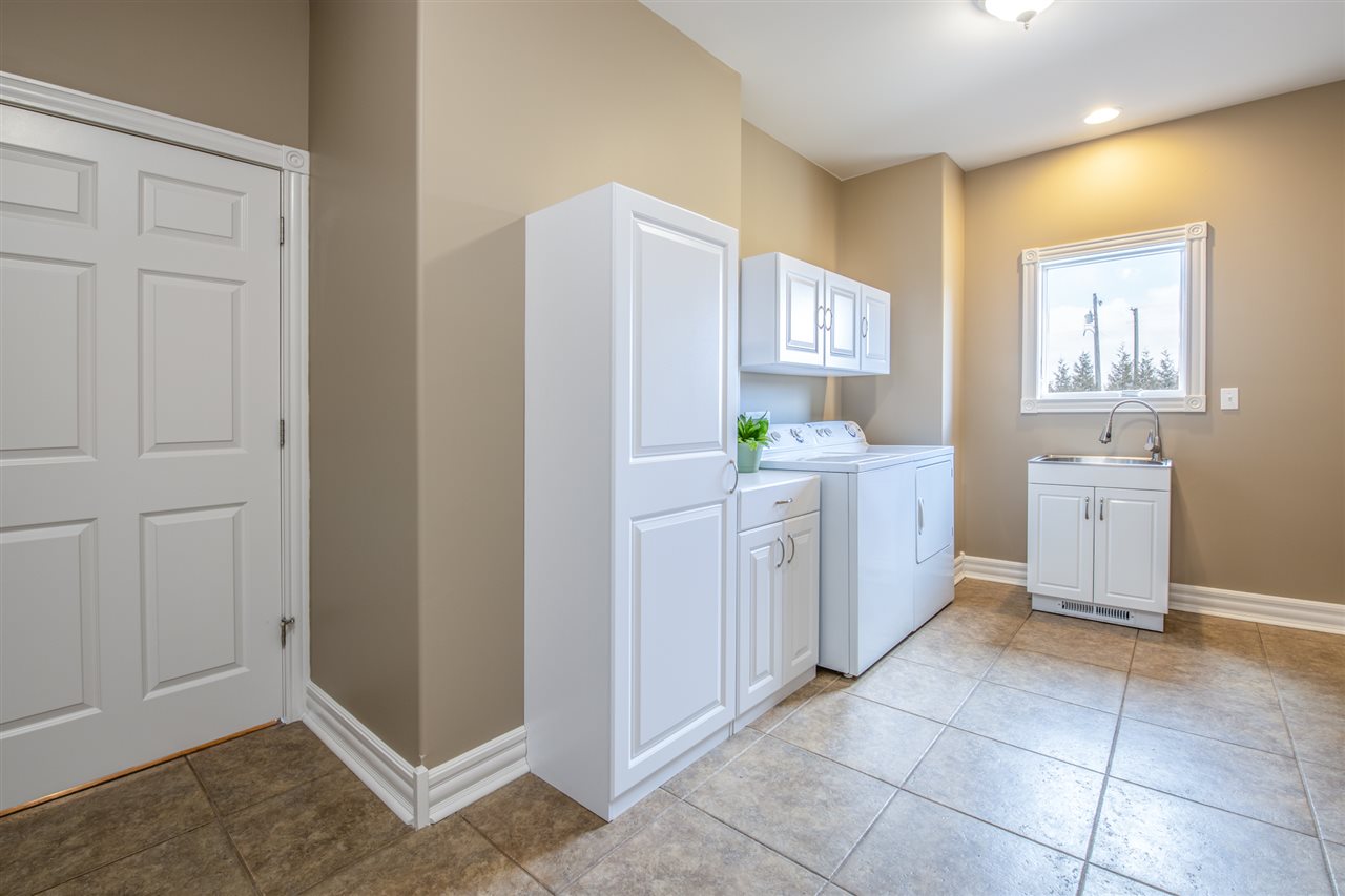 3097 North Marrill Road Byron, IL 61010 - Photo 14 of 40 a utility room with cabinets washer and dryer