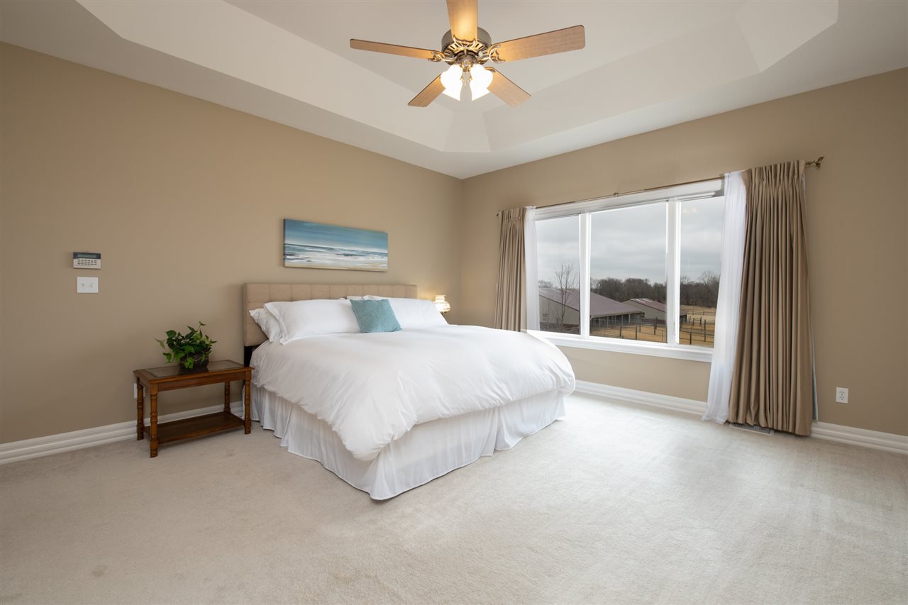 3097 North Marrill Road Byron, IL 61010 - Photo 15 of 40 a spacious bedroom with a large bed and a chandelier
