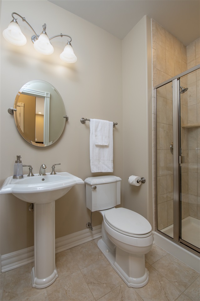 3097 North Marrill Road Byron, IL 61010 - Photo 24 of 40 a bathroom with a toilet a sink and mirror