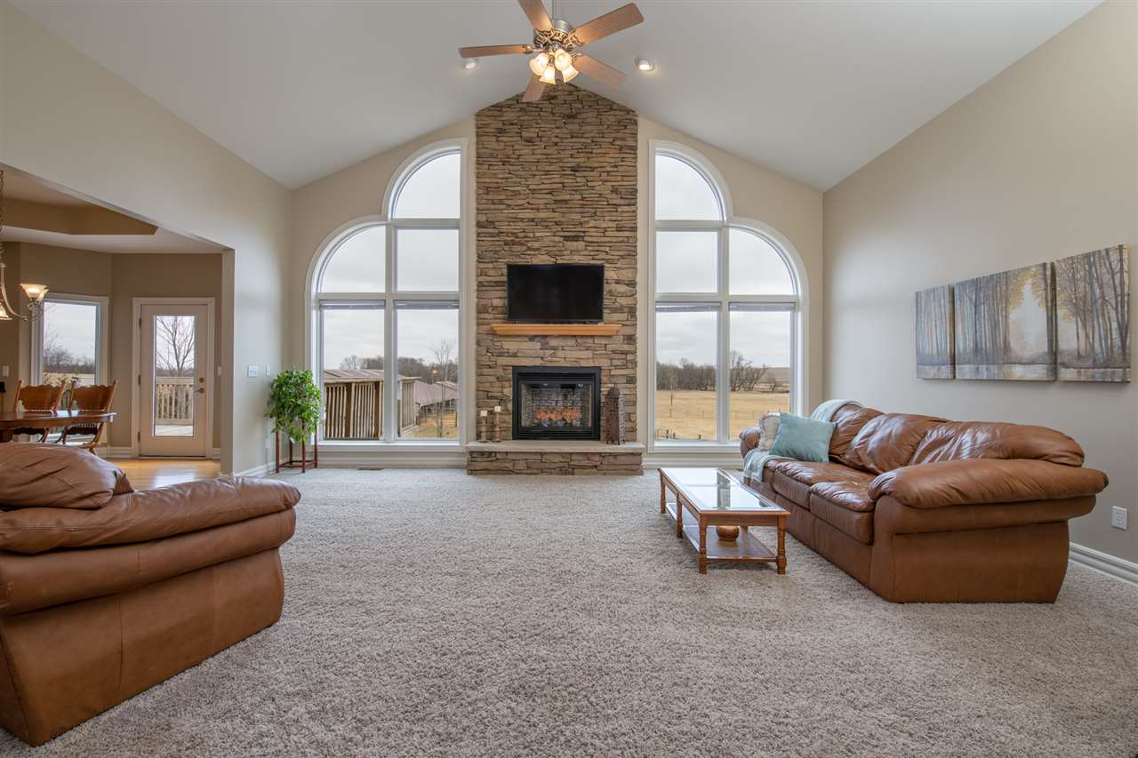 3097 North Marrill Road Byron, IL 61010 - Photo 5 of 40 a living room with furniture a fireplace and a large window