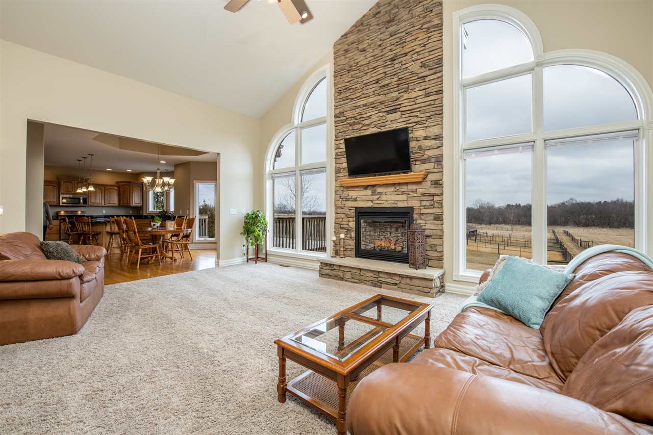 3097 North Marrill Road Byron, IL 61010 - Photo 6 of 40 a living room with furniture fireplace and flat screen tv