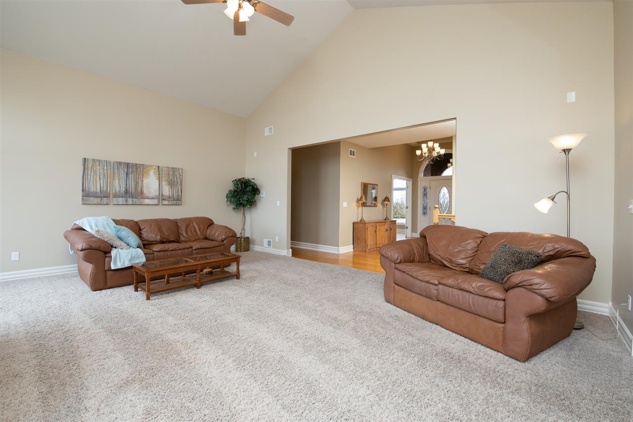 3097 North Marrill Road Byron, IL 61010 - Photo 7 of 40 a living room with furniture and a chandelier