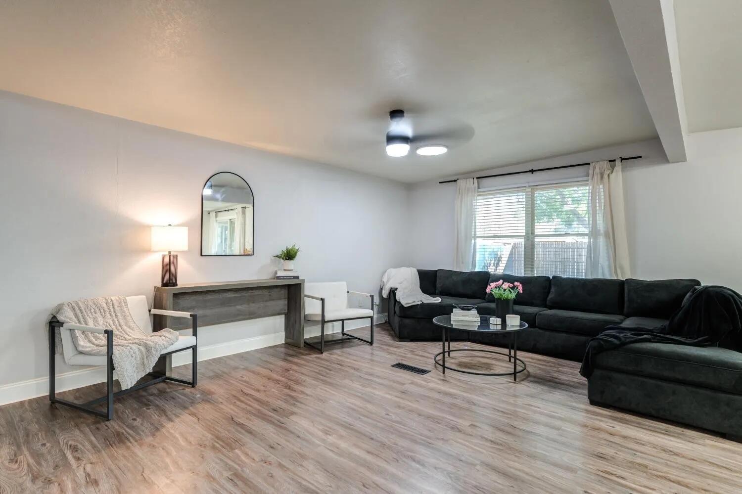 2407 46th Street Lubbock, TX 79412 - Photo 4 of 10 a living room with furniture and a wooden floor
