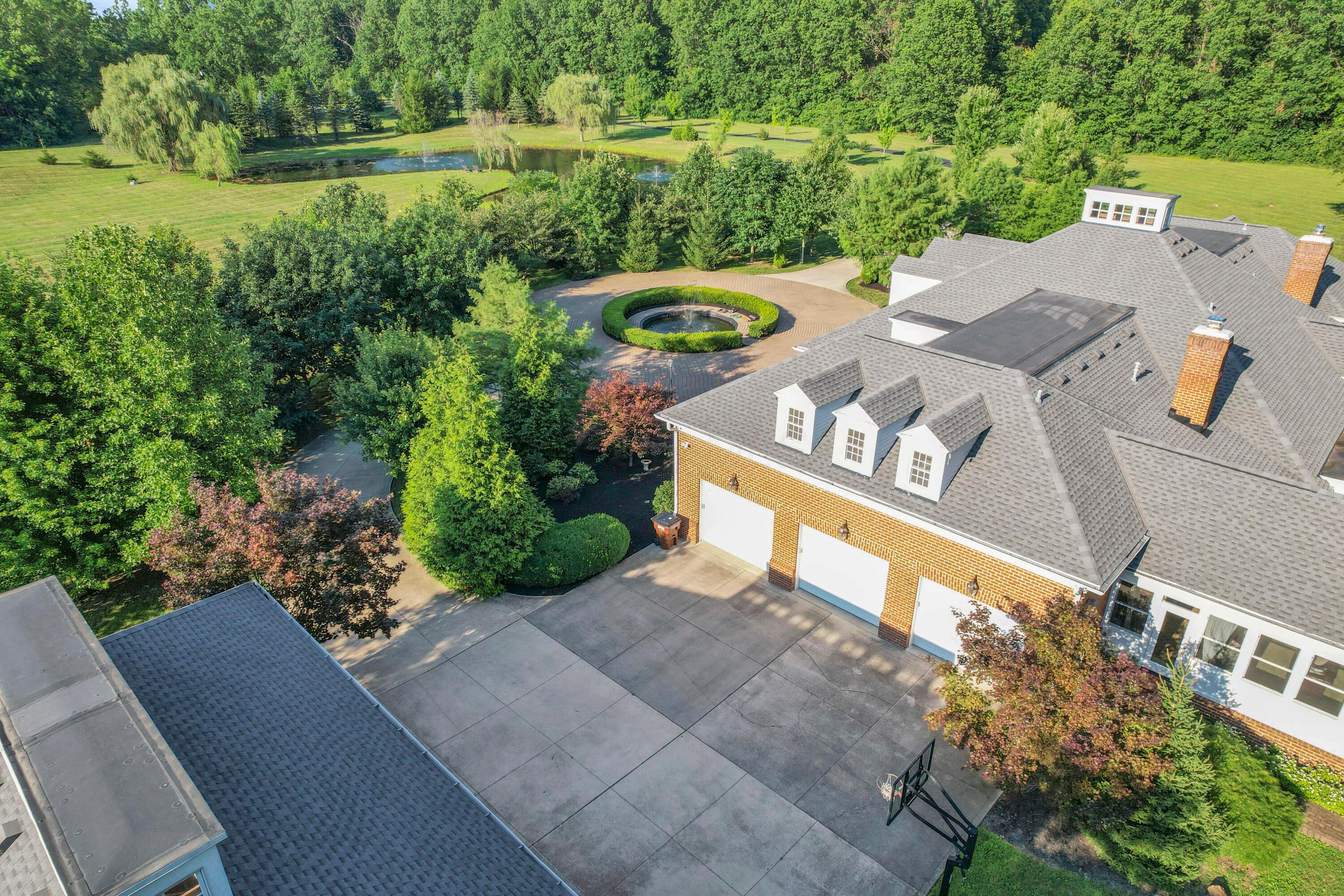 3575 State Rte 37 West Delaware, OH 43015 - Photo 12 of 106 Expansive property featuring a circular driveway, mature landscaping, and a tranquil pond