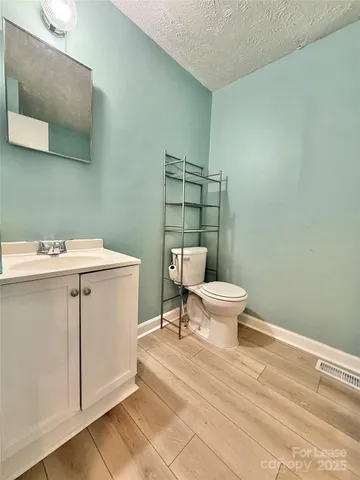 a bathroom with a toilet a sink and a mirror