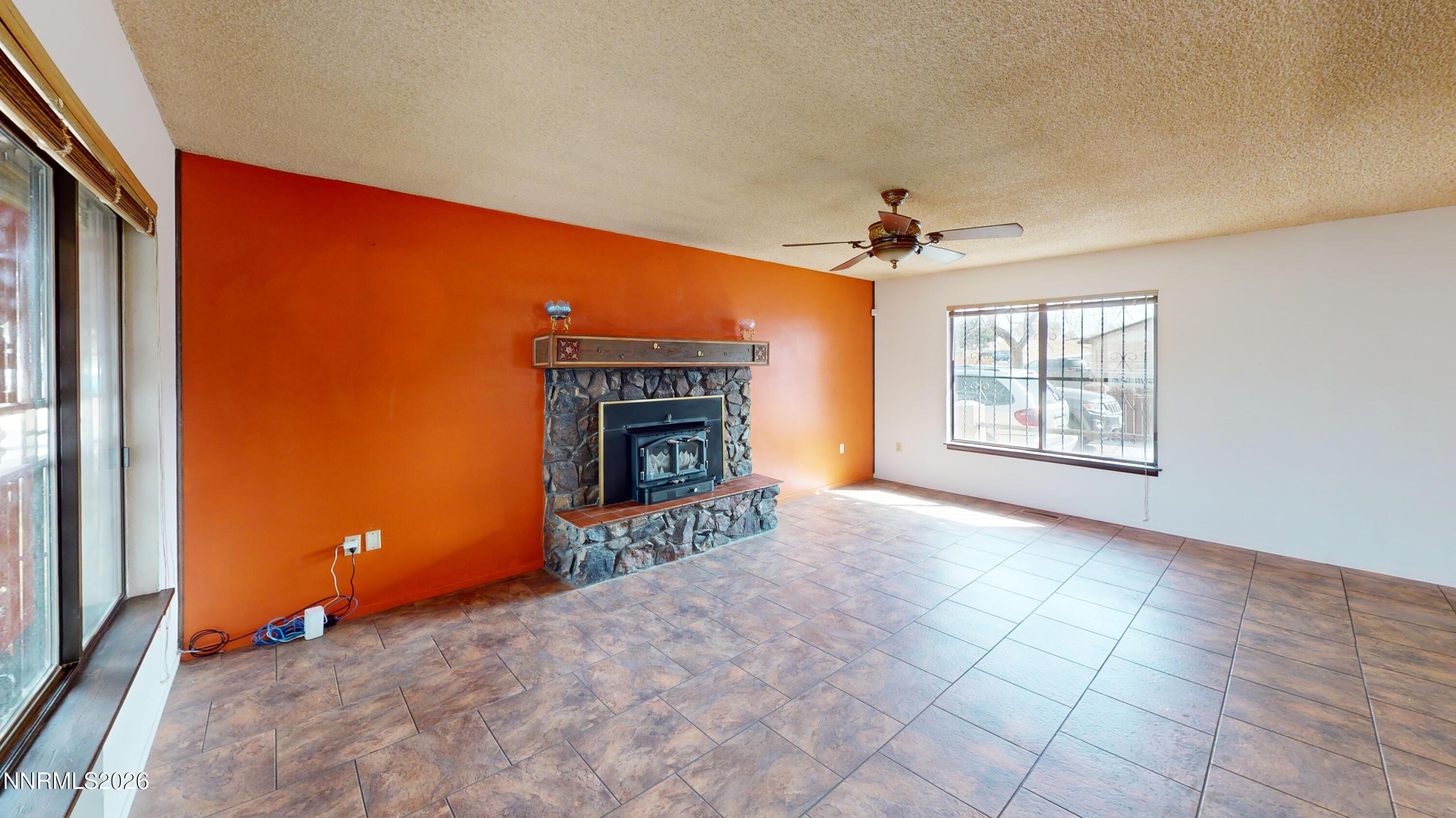 440 East Minor Street Winnemucca, NV 89445 - Photo 5 of 12 an empty room with windows and fireplace