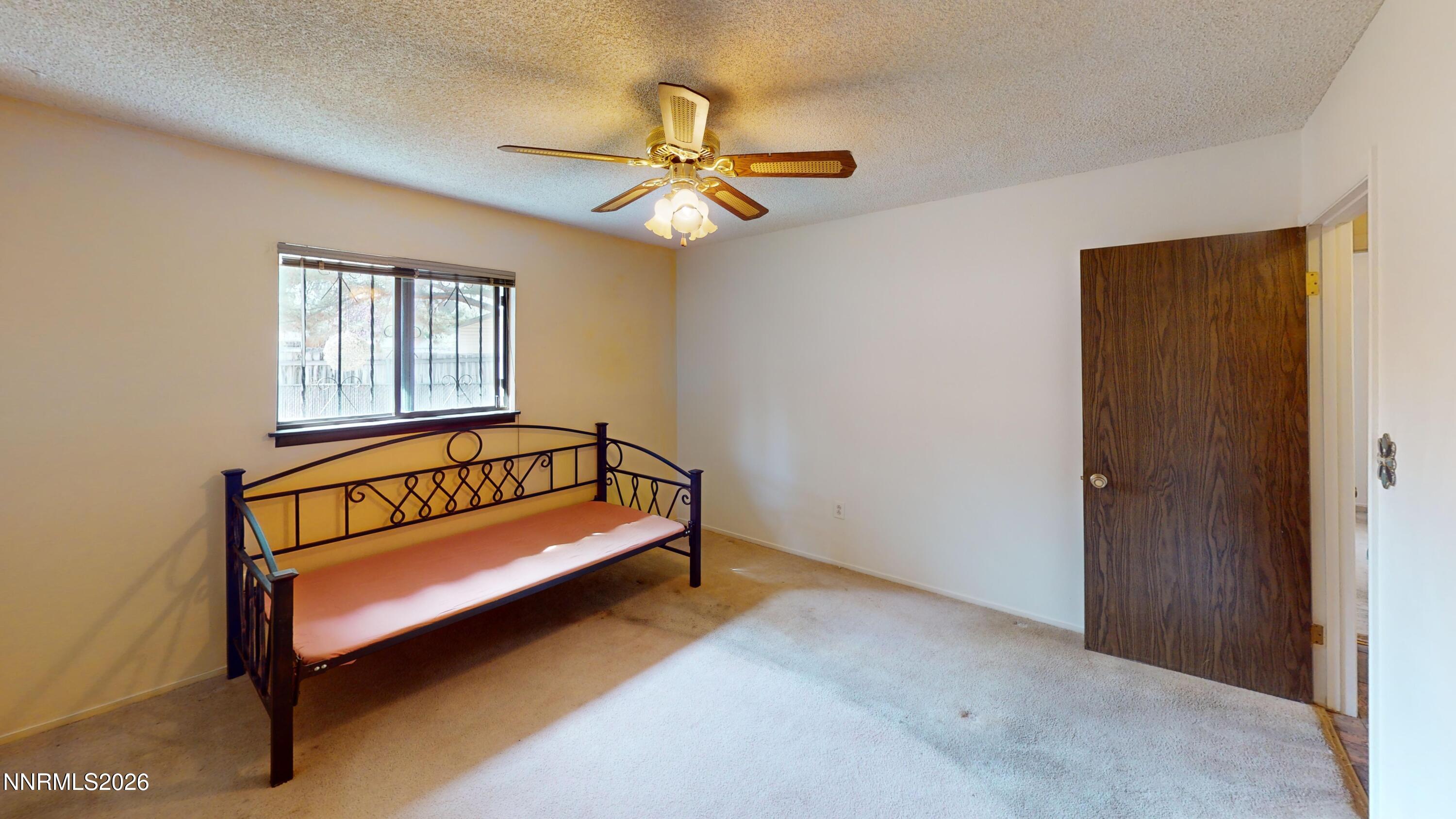 440 East Minor Street Winnemucca, NV 89445 - Photo 10 of 12 a bedroom with a bed and a chandelier