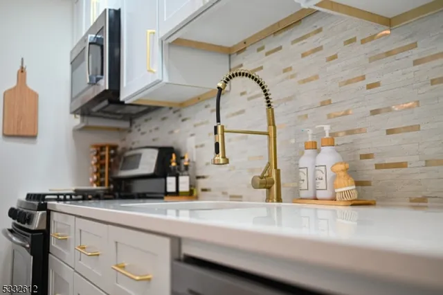 a kitchen with stainless steel appliances granite countertop a sink and cabinets