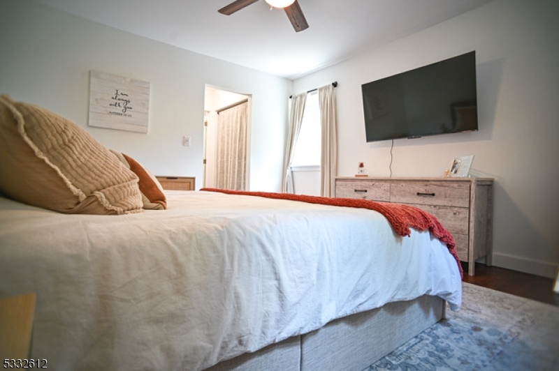 2467 Highway 10, Unit 198A Morris Plains, NJ 07950 - Photo 6 of 8 a bed sitting in a bedroom and a flat screen tv