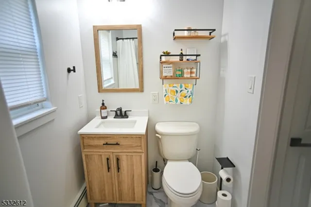 a white toilet sitting next to a bathroom sink