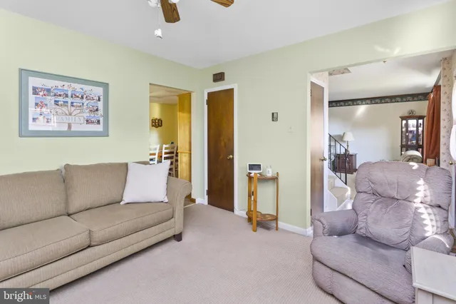 a dining hall with stainless steel appliances granite countertop a sink and a refrigerator