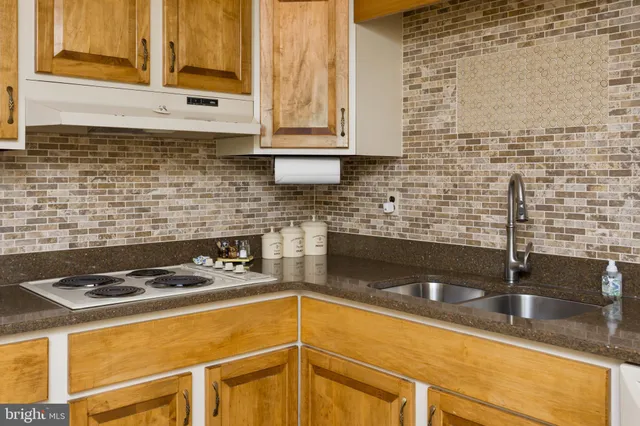 a bathroom with a sink toilet vanity and tub