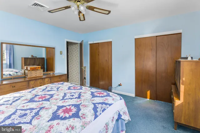 a bedroom with a bed and a dresser