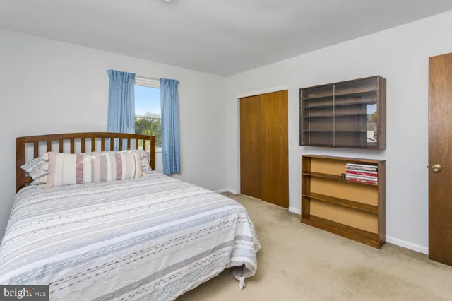 a bedroom with a bed and a wall