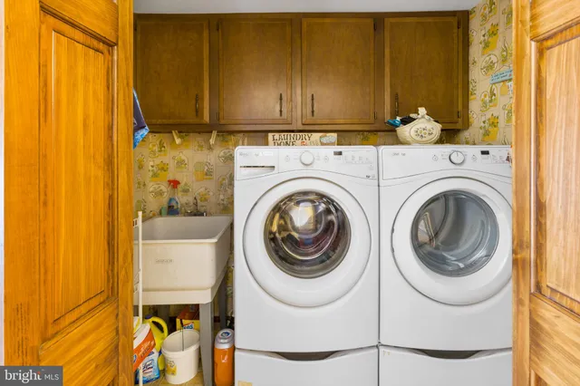a view of a hallway with wooden floor and windows
