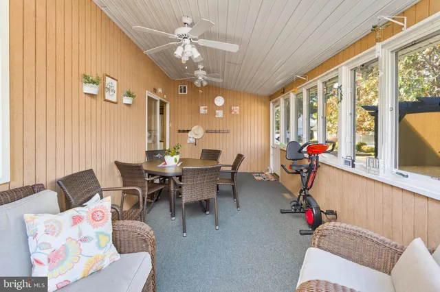 a view of a dining room with furniture large windows and wooden floor