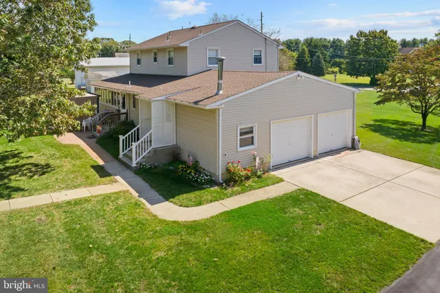 an aerial view of a house with a big yard