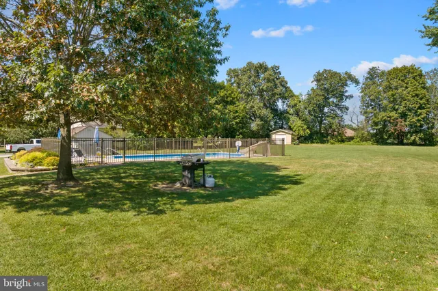 a view of swimming pool yard and outdoor seating