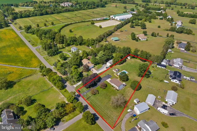 an aerial view of a residential houses with outdoor space