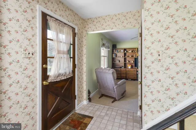 a view of living room with furniture and a fireplace