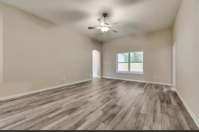 wooden floor in an empty room with a window
