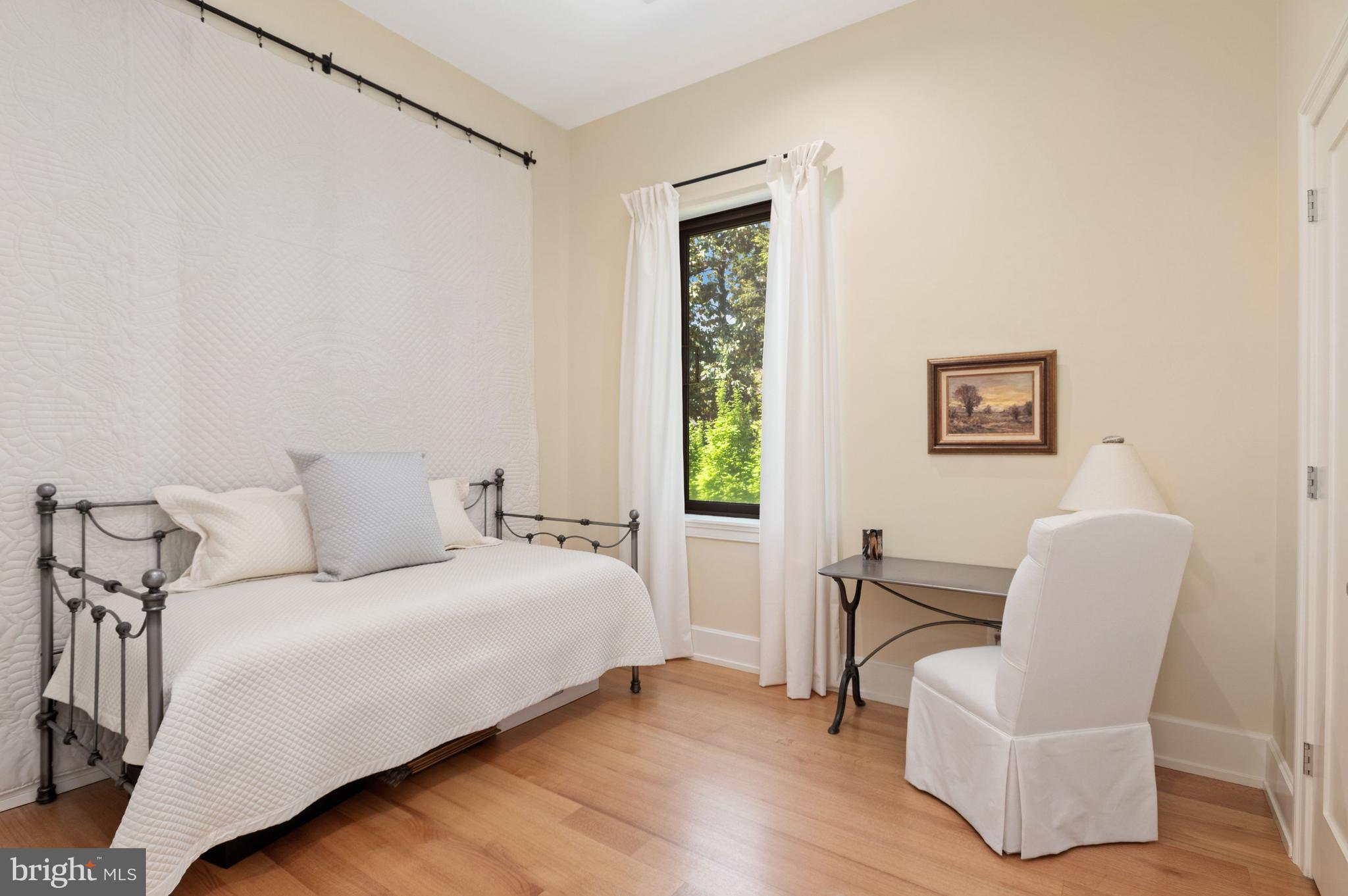 2516 Q Street Northwest, Unit C201 Washington, DC 20007 - Photo 15 of 20 a bedroom with a bed and a chair