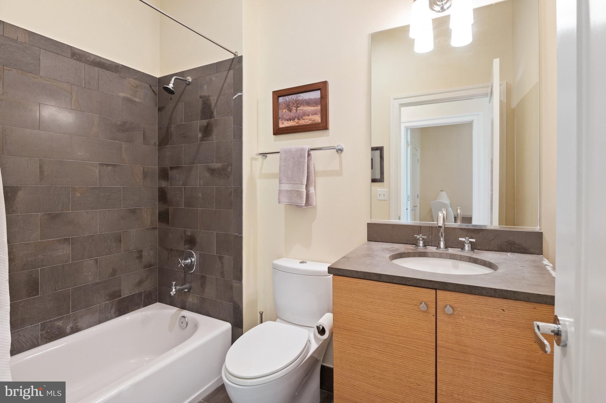 2516 Q Street Northwest, Unit C201 Washington, DC 20007 - Photo 16 of 20 a bathroom with a granite countertop sink toilet and shower