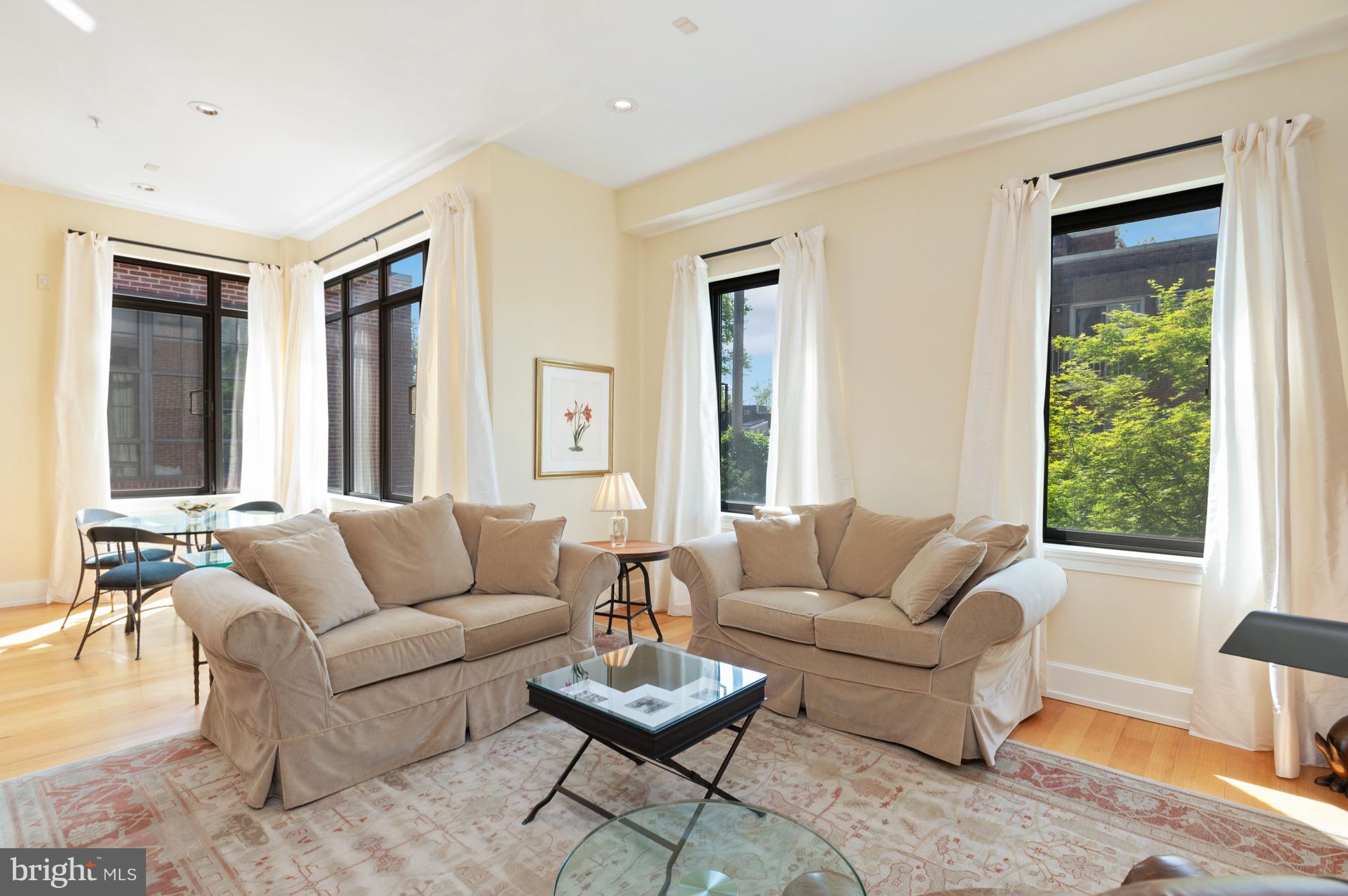 2516 Q Street Northwest, Unit C201 Washington, DC 20007 - Photo 2 of 20 a living room with furniture and a large window