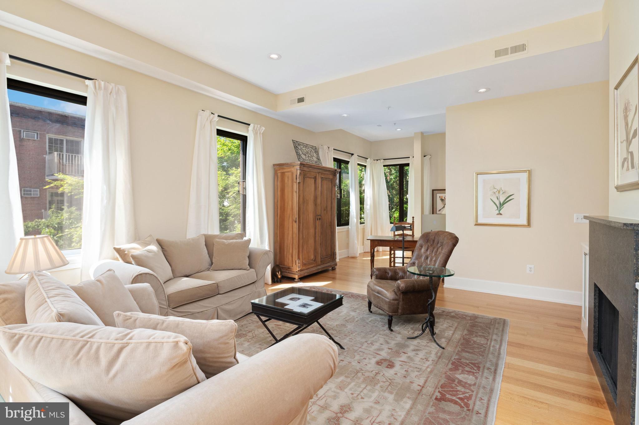 2516 Q Street Northwest, Unit C201 Washington, DC 20007 - Photo 3 of 20 a living room with furniture and a fireplace