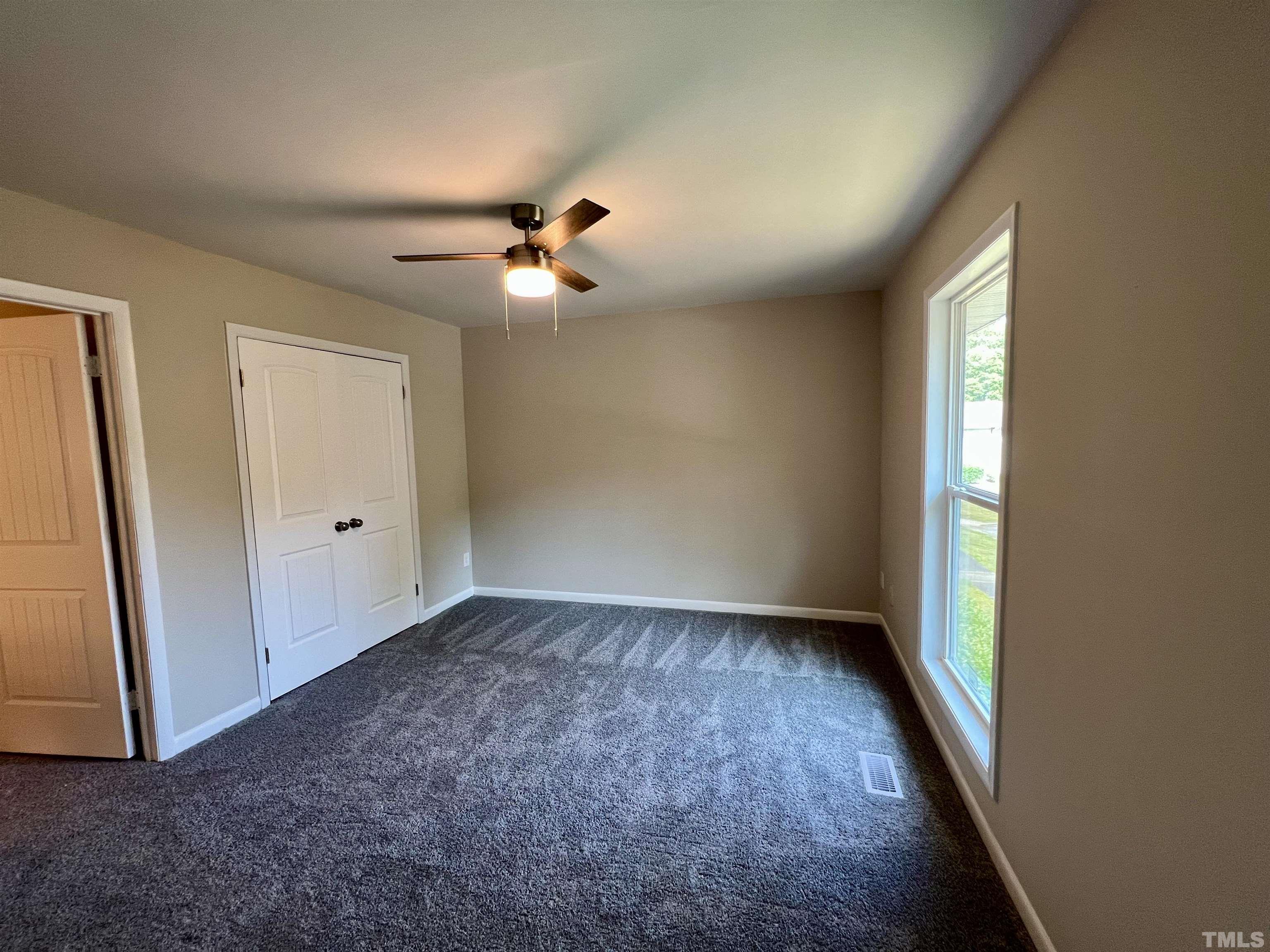 1304 Seaton Road Durham, NC 27713 - Photo 11 of 18 an empty room with windows and fan