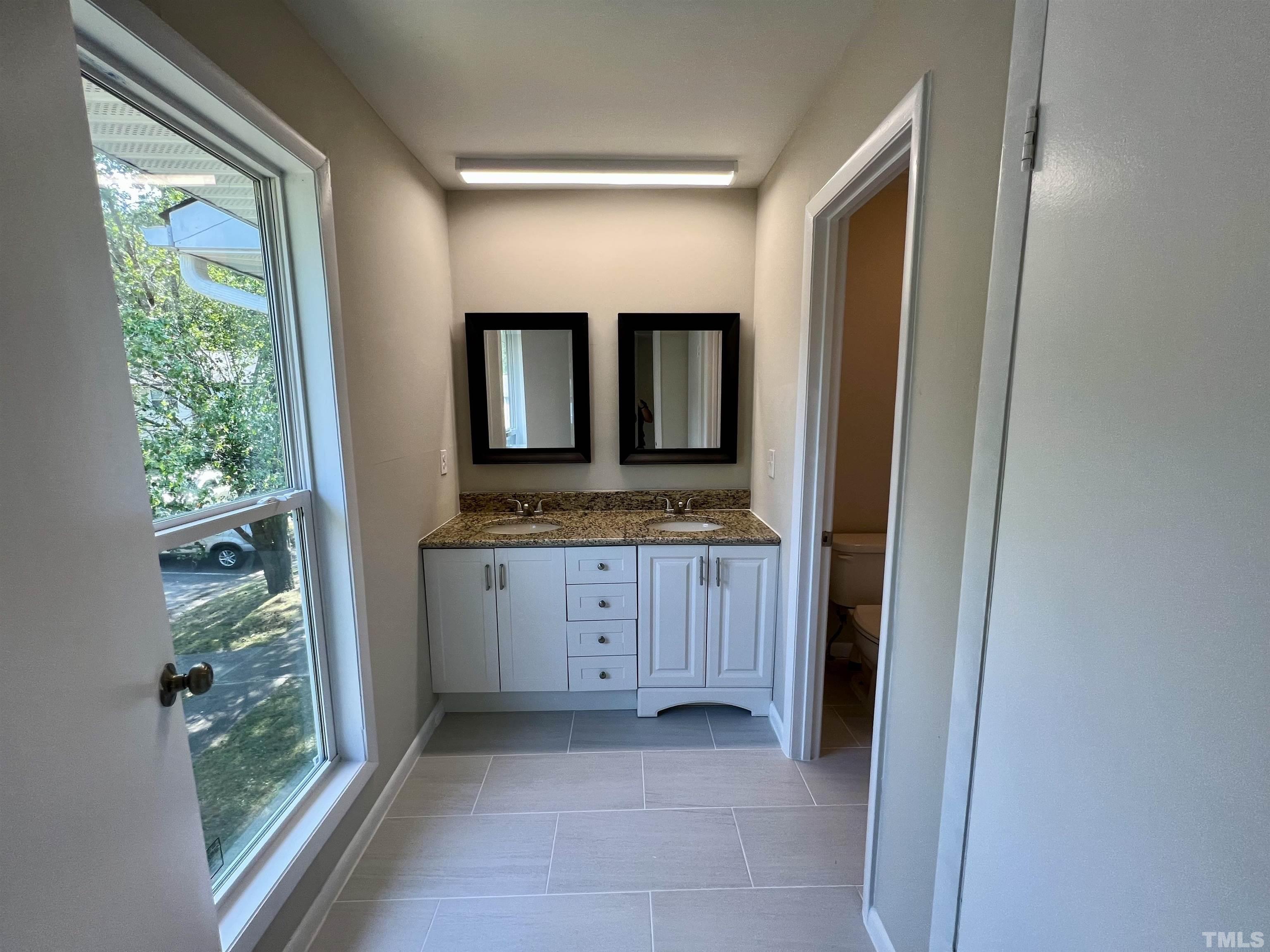 1304 Seaton Road Durham, NC 27713 - Photo 13 of 18 a bathroom with a granite countertop sink and a mirror