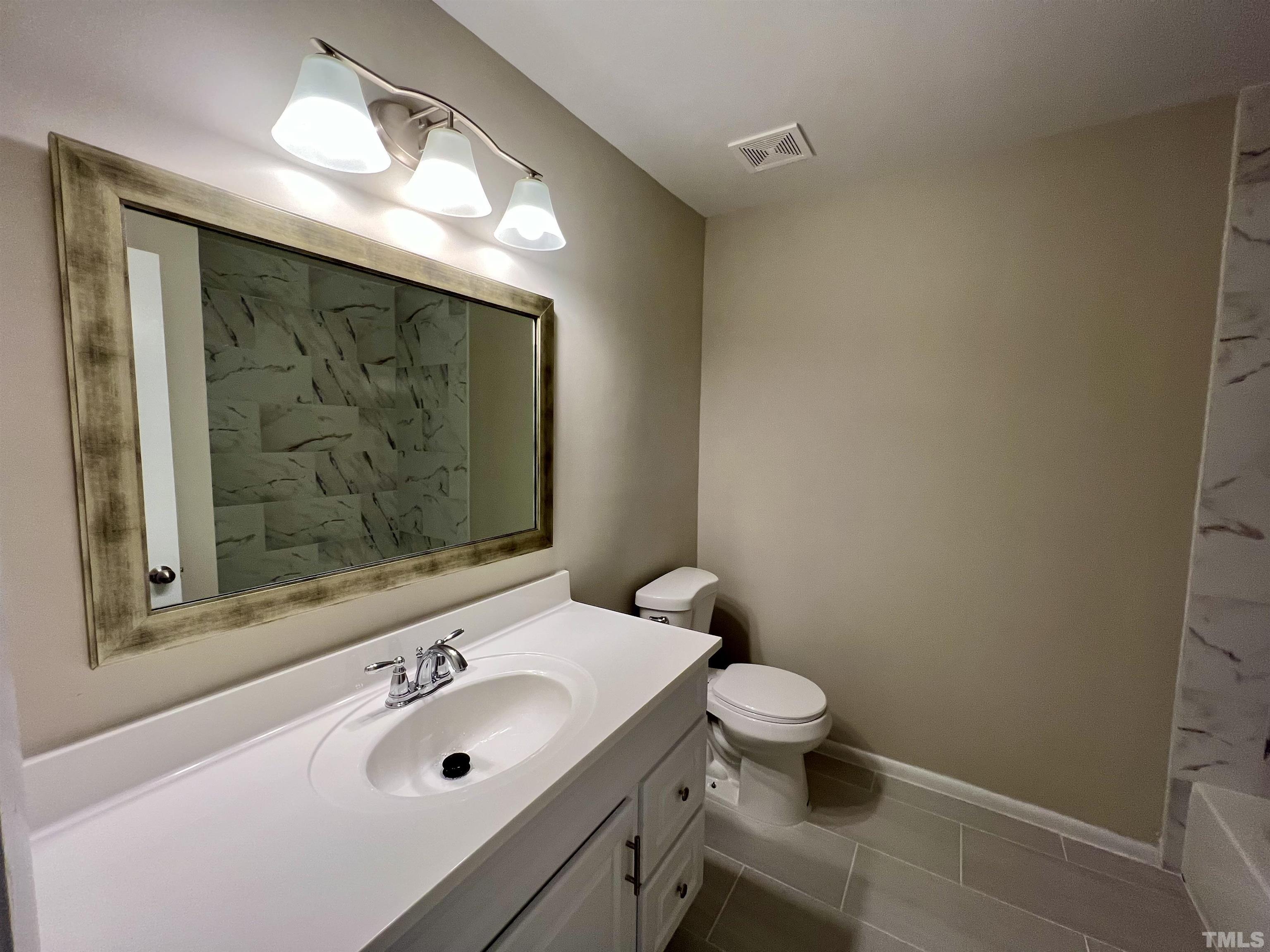 1304 Seaton Road Durham, NC 27713 - Photo 17 of 18 a bathroom with a sink and a mirror