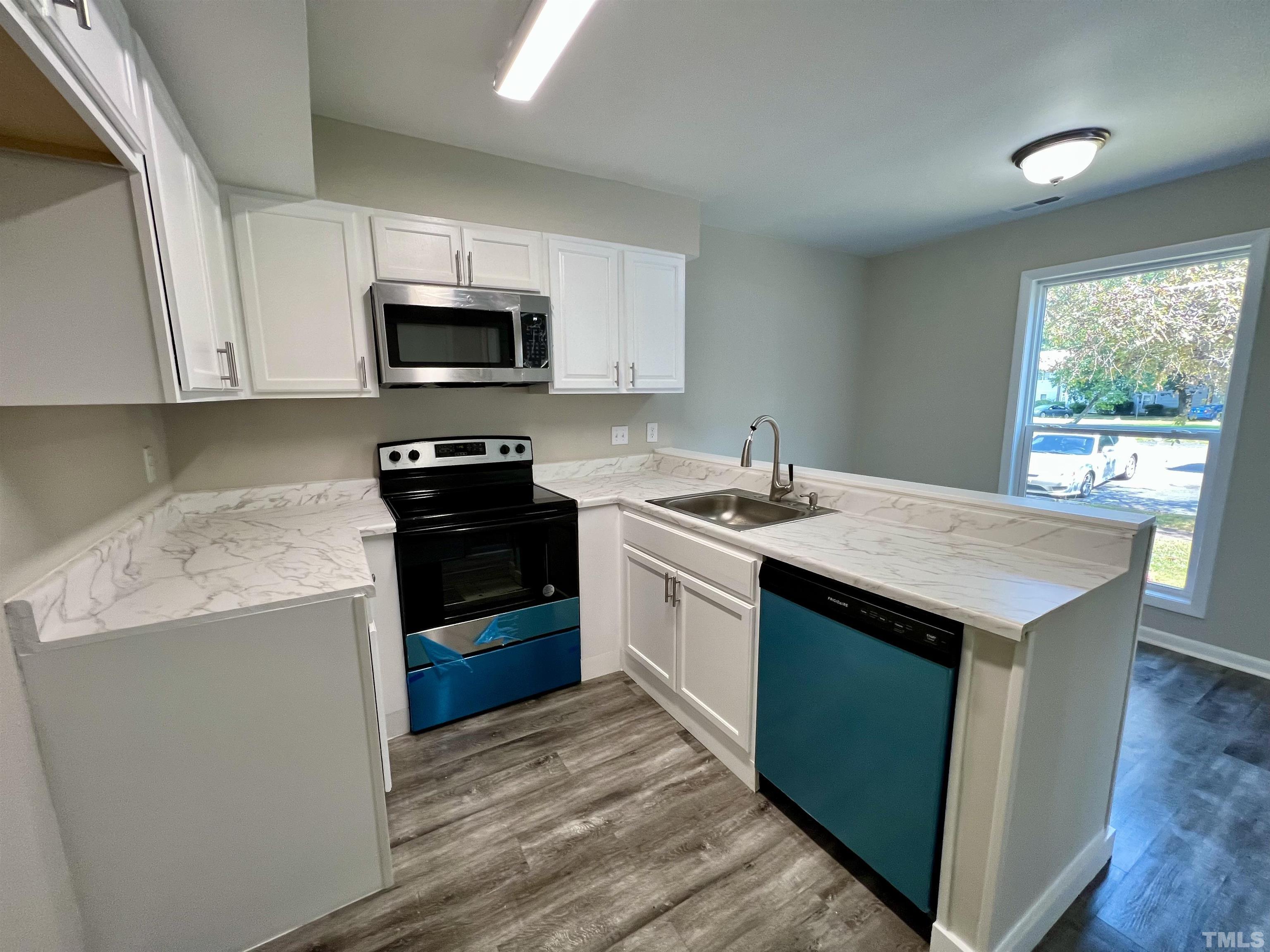 1304 Seaton Road Durham, NC 27713 - Photo 4 of 18 a kitchen with a sink and a stove top oven
