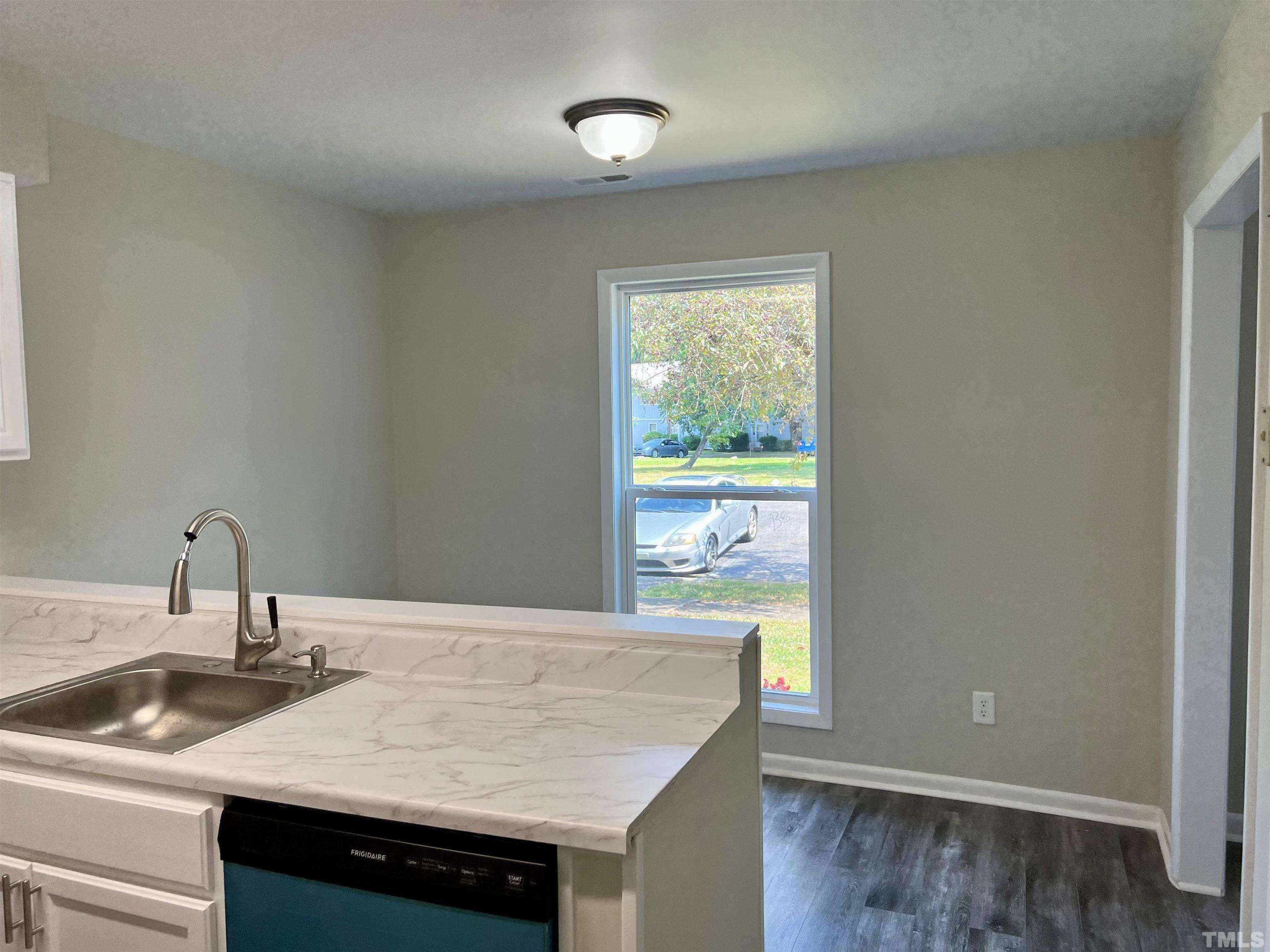 1304 Seaton Road Durham, NC 27713 - Photo 5 of 18 a kitchen with a sink a counter space and a window