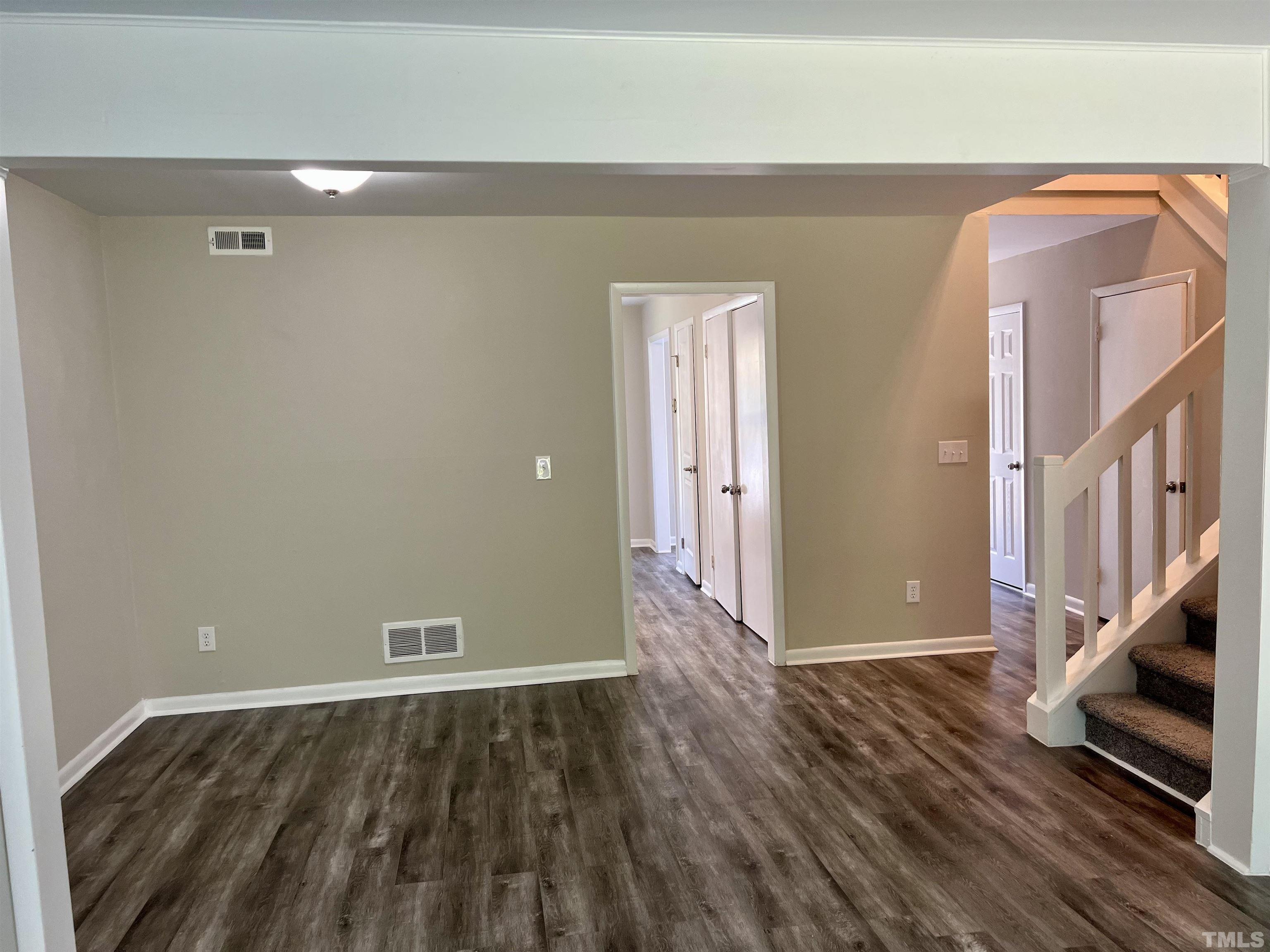 1304 Seaton Road Durham, NC 27713 - Photo 6 of 18 a view of an empty room with wooden floor and a window