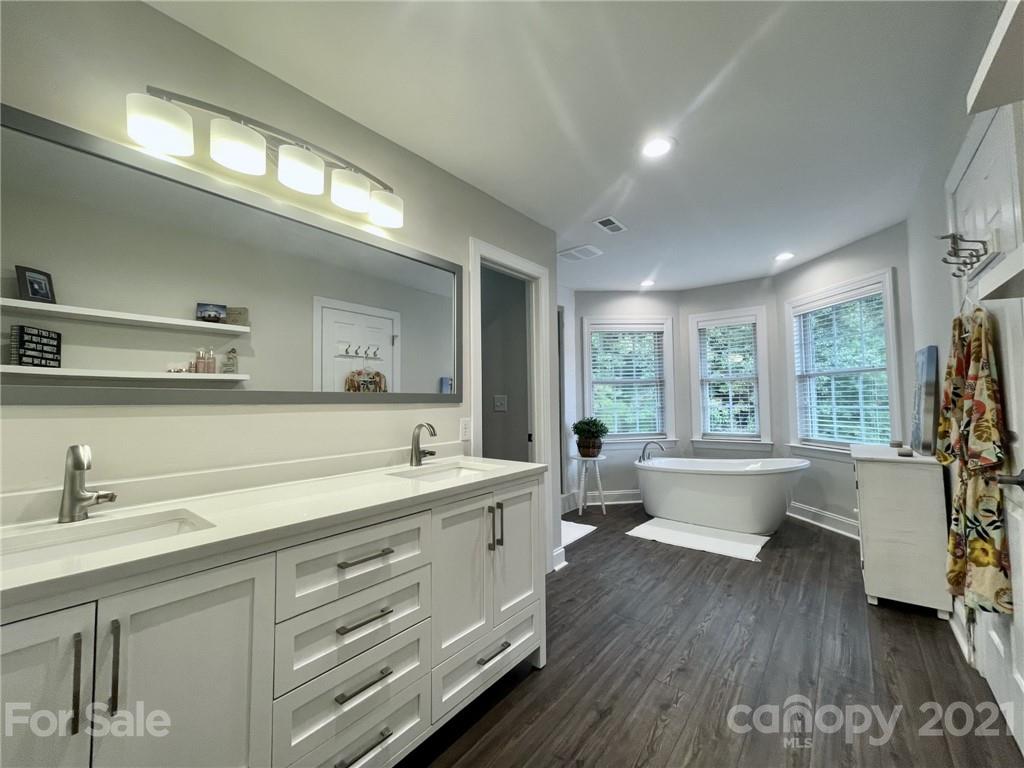 4004 Lamington Road Matthews, NC 28105 - Photo 15 of 31 a spacious bathroom with a double vanity sink a mirror and a bathtub