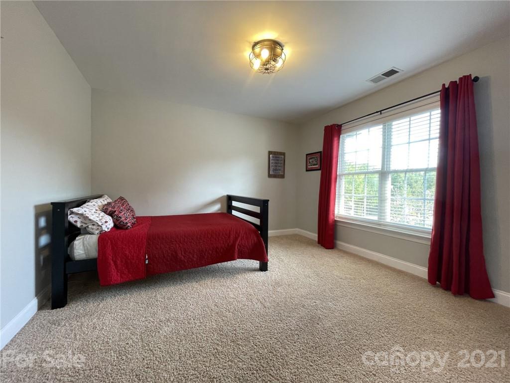 4004 Lamington Road Matthews, NC 28105 - Photo 19 of 31 a spacious bedroom with a bed and a window