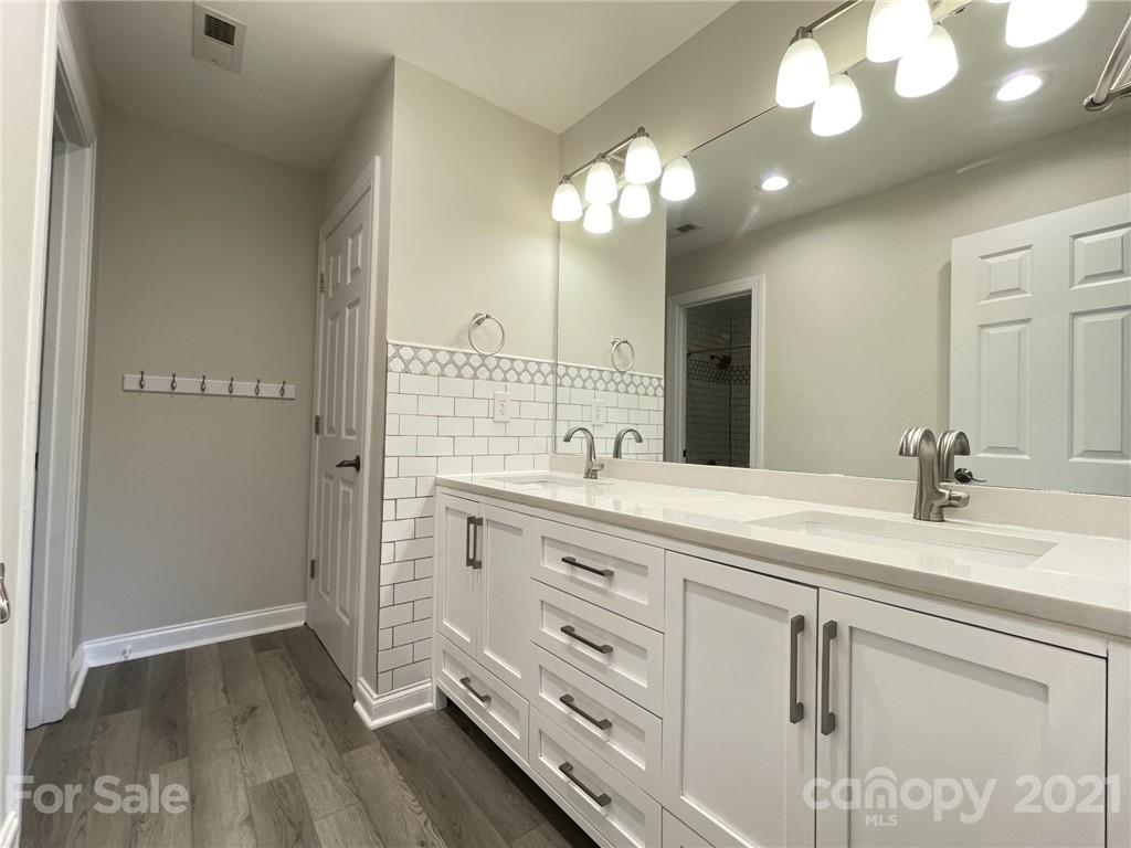 4004 Lamington Road Matthews, NC 28105 - Photo 21 of 31 a bathroom with a double vanity sink and a mirror
