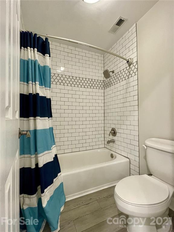 4004 Lamington Road Matthews, NC 28105 - Photo 22 of 31 a bathroom with a toilet and a bathtub