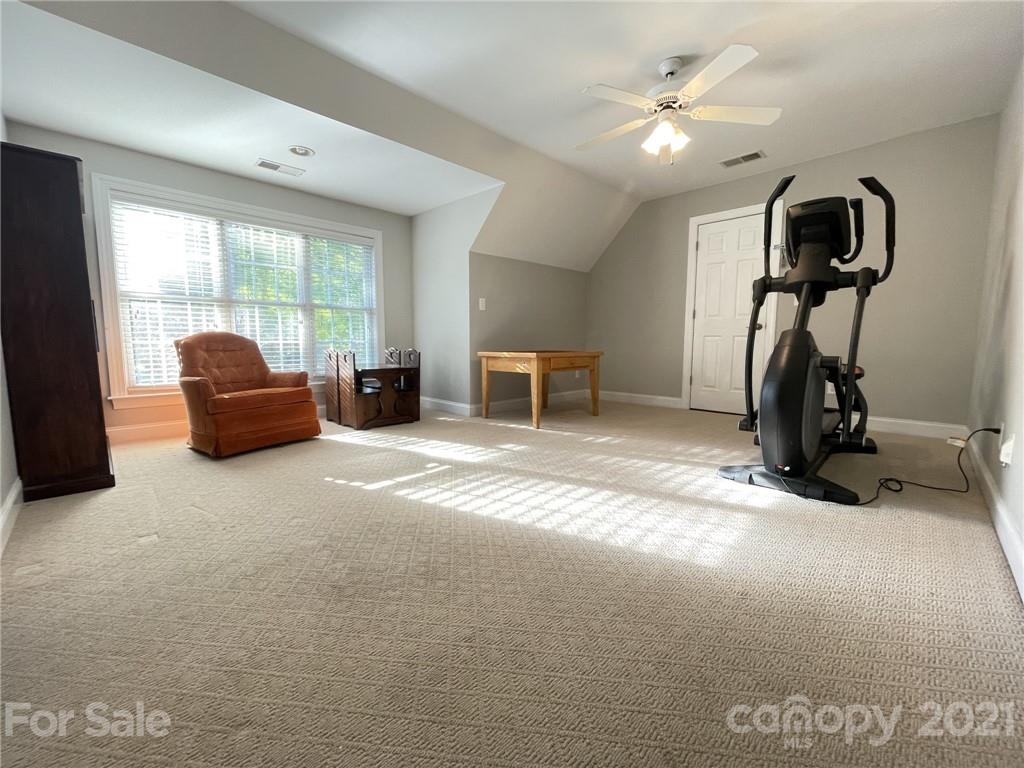 4004 Lamington Road Matthews, NC 28105 - Photo 23 of 31 a living room with furniture a window and gym equipment